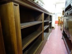Polished wood three section multi-shelf bookcase, approx 3m long