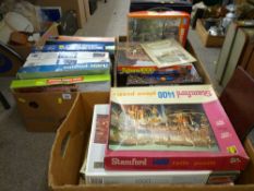 Three boxes of various jigsaws