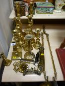 Several pairs of brass candlesticks and other brass items including scales, horse brasses etc