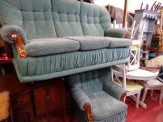 Modern compact green floral upholstered three seater settee and matching armchair