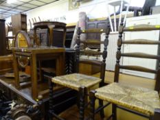 Smoked glass topped nest of three tables and two ladderback rush seated chairs