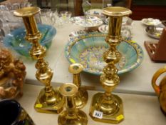 Pair of brass squat candlesticks and a pair of 'King of Diamond' candlesticks