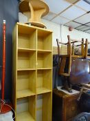 Modern multi-shelf bookcase and small circular occasional table