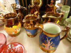 Quantity of copper lustre jugs