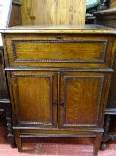 Polished wood cabinet with lift-up lid and twin beaded doors