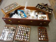 Wood drawer containing a large quantity of collector's thimbles, some in racks