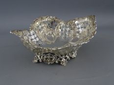 AN OVAL SHAPED PEDESTAL SILVER BASKET having extensive lattice and scrolled decoration on a floral