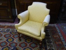 AN ANTIQUE WALNUT SALON ARMCHAIR with turned and shaped stretcher, stamped number to the rear leg