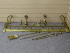 A VICTORIAN BRASS MATCHED SET OF FIRE FENDER, PAIR OF ROSETTE DOGS & SET OF THREE IRONS, 134 cms