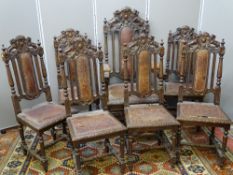 A GOOD SET OF SEVEN (SIX PLUS ONE) VICTORIAN OAK DINING CHAIRS with lion crested top rails, turned