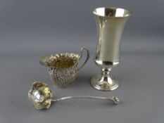 AN OVAL SILVER CREAM JUG with scrolled decoration, 1.3 troy ozs, Birmingham 1892, a silver sugar
