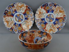 A PAIR OF JAPANESE IMARI SCALLOP EDGE WALL CHARGERS, 30.5 cms diameter and a similarly styled