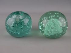 TWO VICTORIAN GREEN GLASS DUMP PAPERWEIGHTS, one having inkwell top, both with bubble inclusions