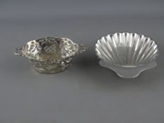 A TWO HANDLED PIERCED BASKET FORM SILVER BON BON DISH and a shell shaped dish on three ball feet,
