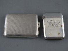 A VICTORIAN SILVER VESTA CASE and a Holmes & Co bookmatch holder, Birmingham 1897 and 1924