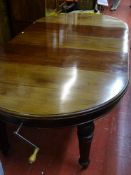 A GOOD LATE VICTORIAN MAHOGANY WIND-OUT EXTENDING DINING TABLE with three leaves, moulded edge and