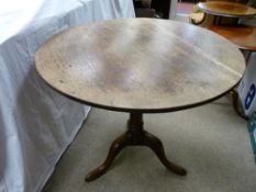 AN ANTIQUE OAK TILT TOP TRIPOD TABLE, 72 cms high, 80 cms diameter the top (catch button absent