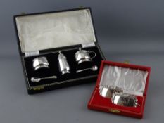 A CASED FIVE PIECE SILVER CONDIMENT SET and a boxed pair of German silver whisky labels,