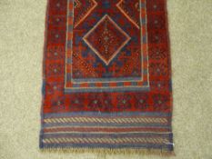 A MESHWANI CARPET RUNNER, red and blue ground with repeating diamond central pattern and
