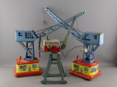 THREE TINPLATE TOY CRANES including two Western Germany clockwork examples and a Bandai Toys