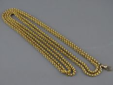 A NINE CARAT GOLD MUFF CHAIN, approximately 140 cms long but at present in double form with