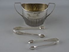 A REEDED TWO HANDLED SILVER SUGAR BASIN, Chester 1901 and two pairs of silver sugar tongs, London