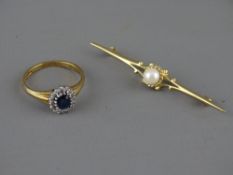 A NINE CARAT GOLD SAPPHIRE & DIAMOND DRESS RING and a single pearl set nine carat gold bar brooch,