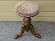 A VICTORIAN MAHOGANY RISE & FALL CIRCULAR PIANO STOOL on a turned column and tripod base with button