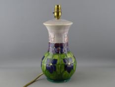 A MOORCROFT 'VIOLET' TABLE LAMP designed by Sally Tuffin, 32 cms high including fitting, impressed