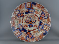 A LARGE JAPANESE IMARI WALL CHARGER with lobed edge, 47 cms diameter