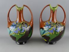 A PAIR OF ART NOUVEAU TWIN HANDLED ARNHEM POTTERY VASES, the bases marked HB with a cockerel, 18
