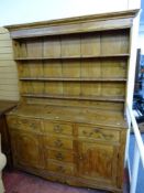 AN EARLY 19th CENTURY PINE NORTH WALES DRESSER having a three shelf rack with wide back boards