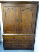 A GEORGE III OAK PRESS CUPBOARD, the interior peg fitted for hanging, peg joined construction,