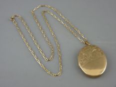 A NINE CARAT GOLD LARGE PENDANT LOCKET on a German eighteen carat gold necklace
