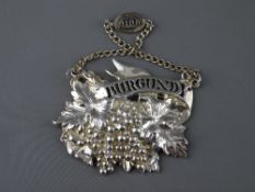 A HUGH JOHNSON COLLECTION SILVER WINE LABEL, heavy quality design of grapes and vine leaves, pierced