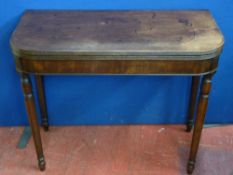 A REGENCY MAHOGANY FOLDING TEA TABLE on tapering turned supports, 74.5 cms high, 91 cms wide, 44.