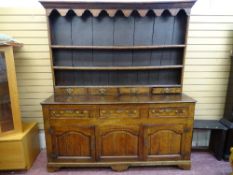 A GEORGE III OAK & ELM SPICE DRAWER NORTH WALES DRESSER, the three shelf rack with decorative canopy