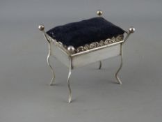 A VELVET TOPPED SILVER TRINKET BOX with mirrored interior in the form of a box seat piano stool, 8