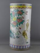A CHINESE POTTERY STICKSTAND, 46 cms high decorated with herons and foliage, with character