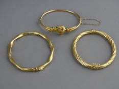THREE NINE CARAT GOLD HOLLOW BRACELETS of various patterns, 26 grms