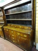 A GEORGE III NORTH WALES OAK SPICE DRAWER DRESSER, the three shelf wide boarded rack having five