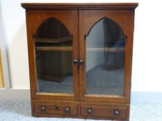 A 19th CENTURY PINE TABLETOP CABINET having twin glazed doors with arched top detail and a pair of