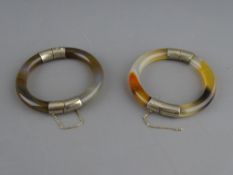 TWO WHITE METAL MOUNTED AGATE BANGLES with safety chains