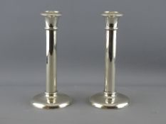 A PAIR OF PLAIN CIRCULAR BASED STRAIGHT COLUMN SILVER CANDLEHOLDERS, 19 cms high, loaded, Birmingham