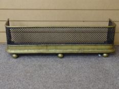 A 19th CENTURY BRASS & PIERCED METAL FIRE FENDER having rounded corners on ball front feet, 86 cms