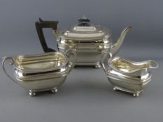 A THREE PIECE SILVER TEA SERVICE, each piece of oblong plain form with lined decoration on four ball