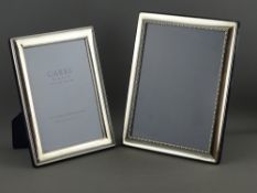 TWO MODERN HALLMARKED SILVER EASEL PHOTOGRAPH FRAMES, both rectangular form, 21.5 x 16 cms,