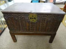 AN 18th CENTURY OAK LIDDED BIBLE BOX on later stand, having carved leaf and floral detail to the