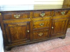 AN ANTIQUE OAK & LATER DRESSER BASE of three frieze drawers over two blind drawers with twin