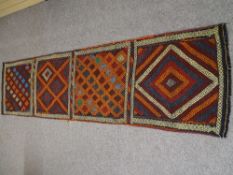 A SUZNI KELIM CARPET RUNNER, multi-coloured in four repeating block patterns with sectional borders,